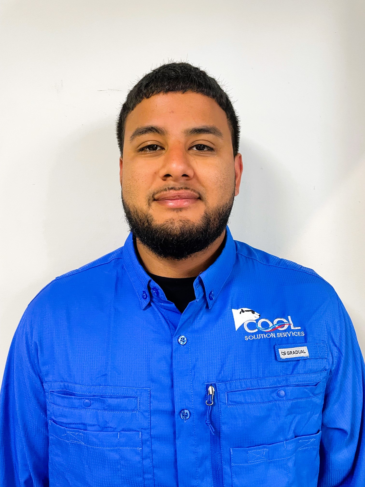 a man in blue dress with cool solution service logo on it is smiling